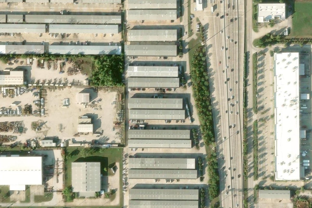 Aerial view of Beltway 8 Business Park — nine parallel buildings with drive aisles between them, Sam Houston Tollway running along the east side.