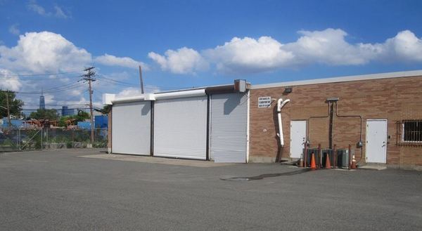 Roll-up drive-in doors at the studio buildings with the Manhattan skyline in the distance