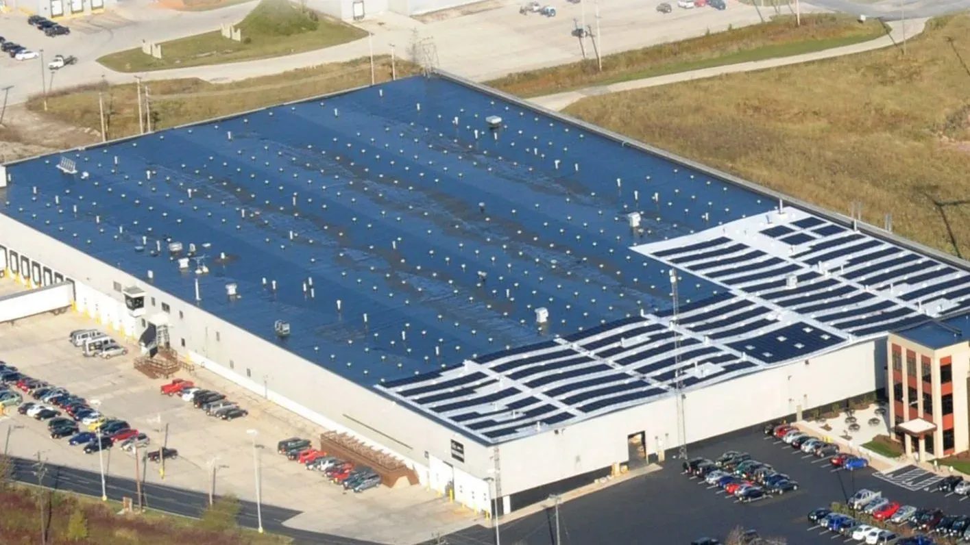 Aerial view of the 266,000 SF facility at 2001 Mirro Drive — dock line on the west side, office block at the corner, solar array on the roof